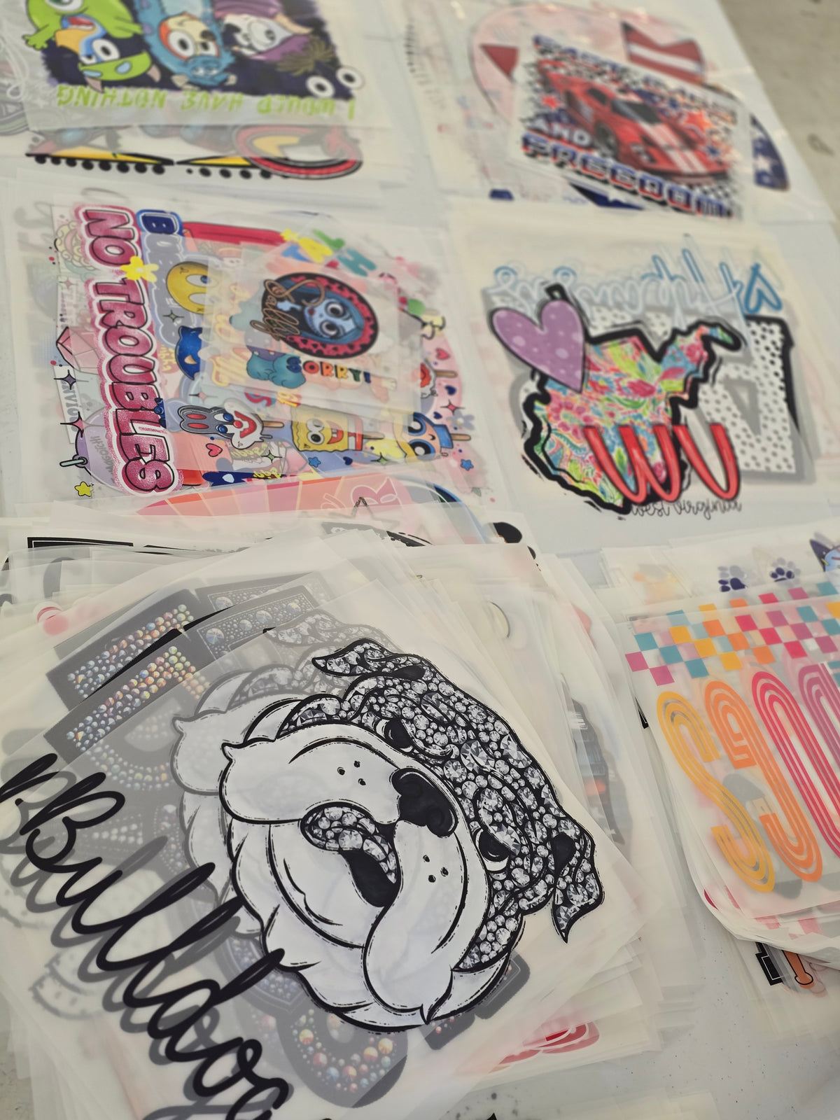 Bundle of 25 dtf transfers. Mixture of all seasons, mascots and sizes.