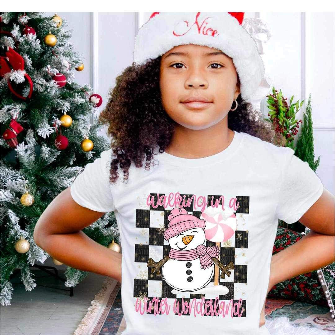 Walking in a winter wonderland (pink font and snowman with checkered background) 16621 DTF Transfer