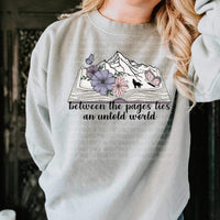 Between the pages lies an untold world (open book with mountains, wolf, and flowers) 9306 DTF TRANSFER