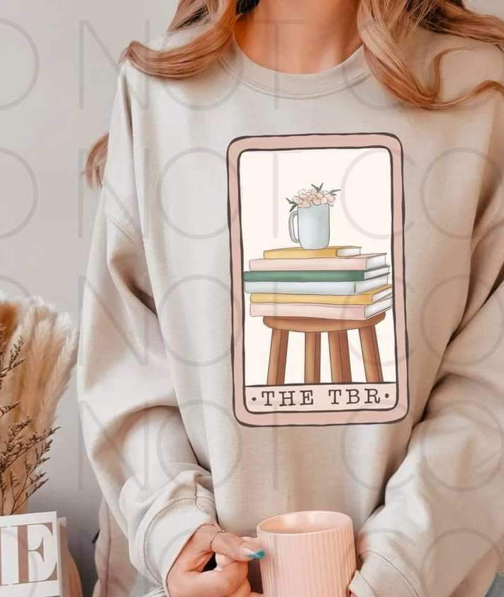 The tbr (card with stack of books on chair with floral mug) 15087 DTF Transfer