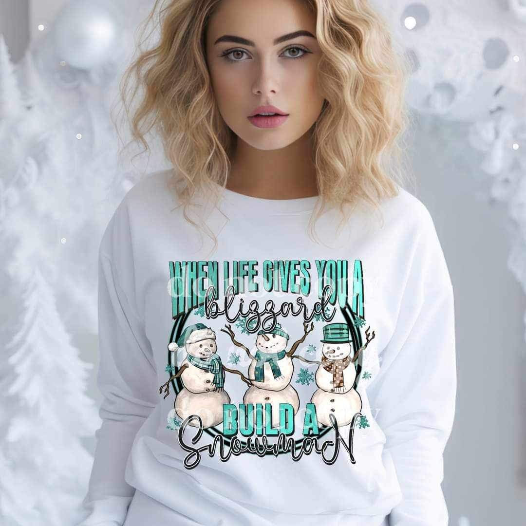 When life gives you a blizzard build a snowman (blue font with three snowmen) 15663 DTF Transfers
