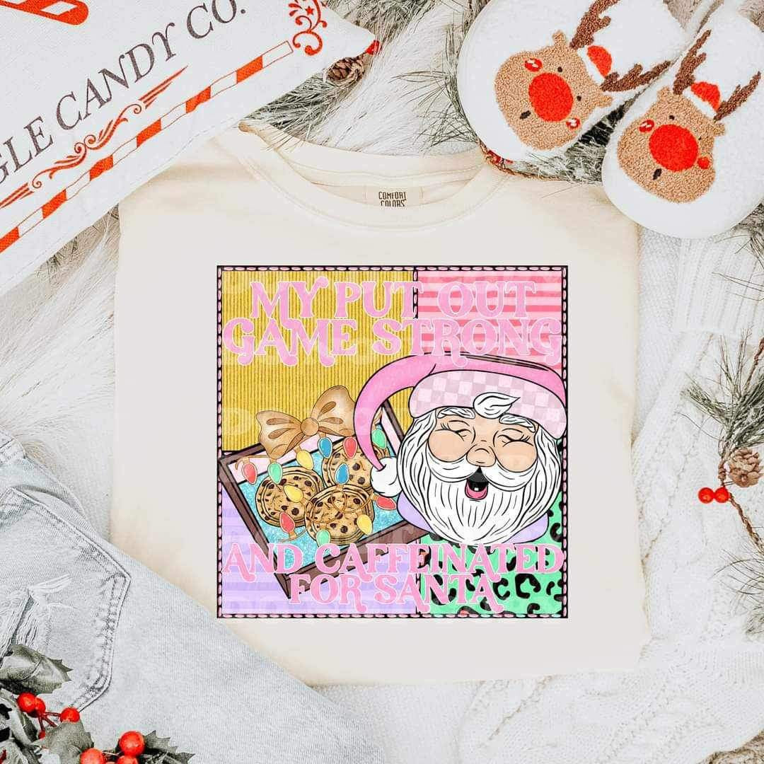 My put out game strong and caffeinated for santa (santa mug, tray of cookies, pink and yellow background) VIRGO 15640 DTF Transferd