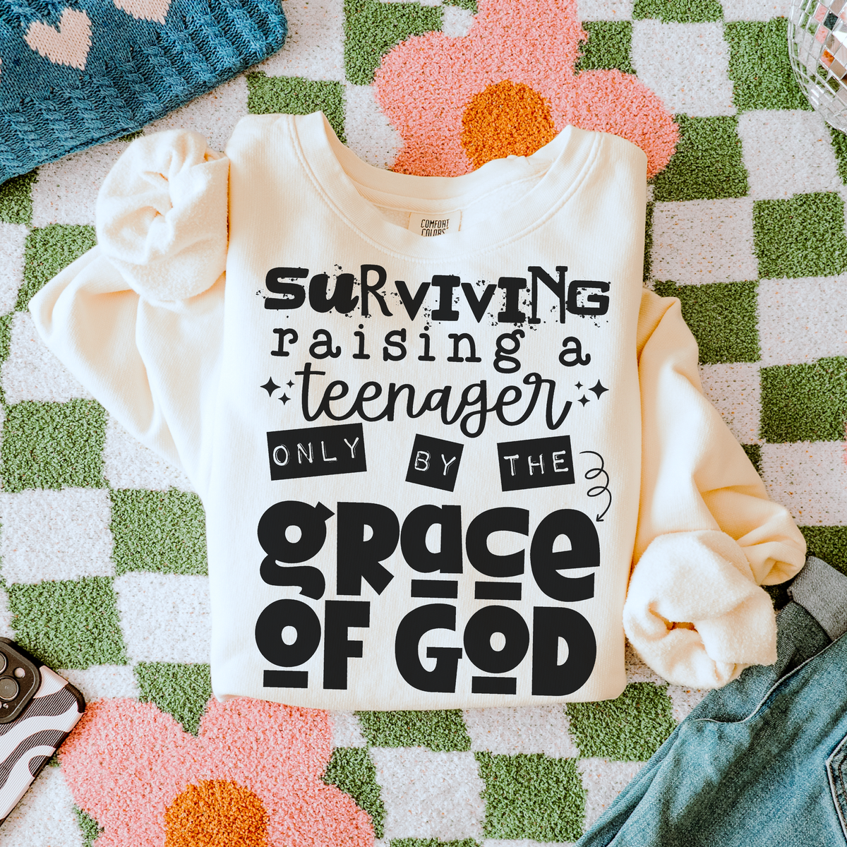 Surviving a teenager by the Grace of God (black) (two peas) DTF Transfer