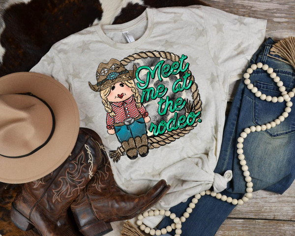 Meet Me At The Rodeo. (cowgirl, rope frame, cowhide background, turquoise lettering) DTF TRANSFER