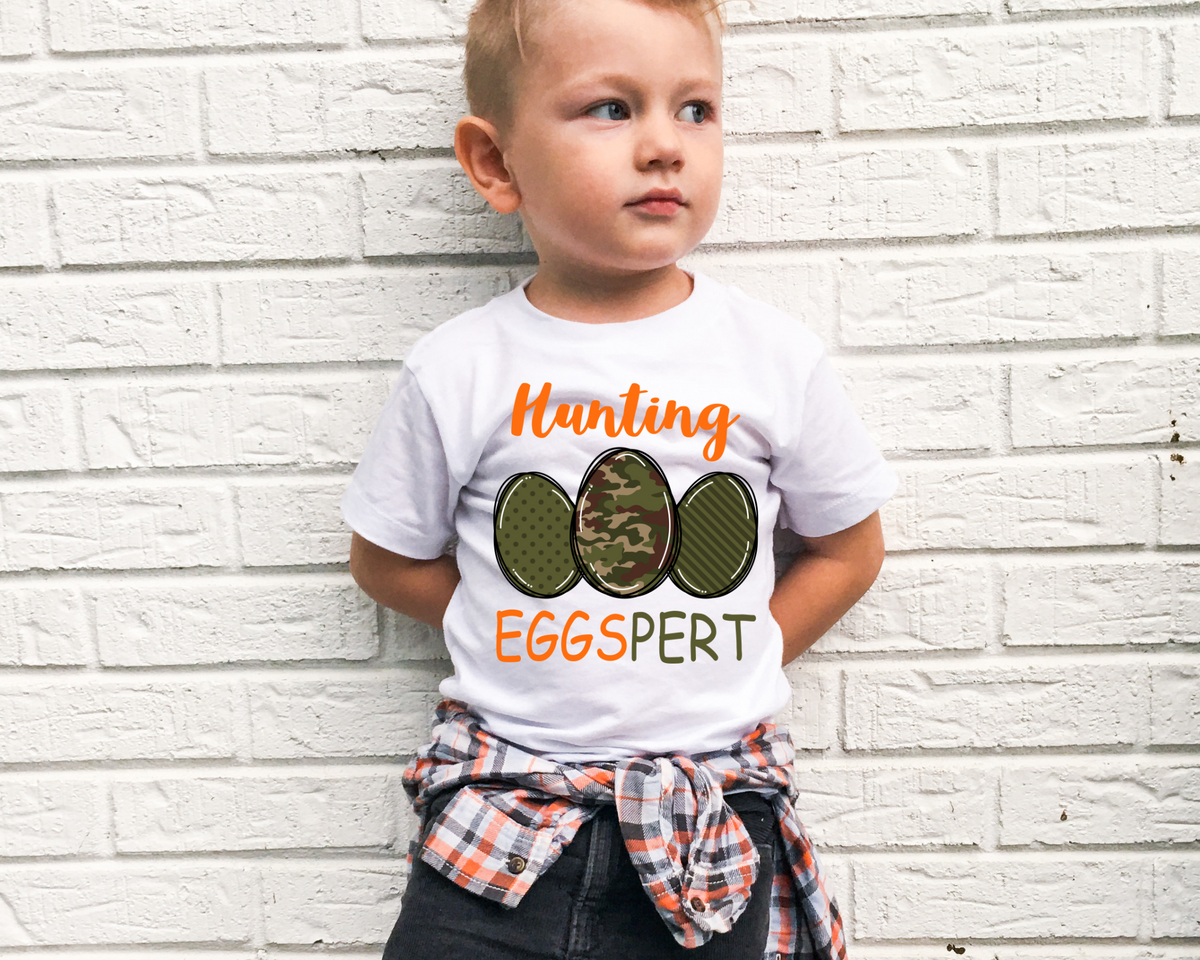 Hunting Eggspert (bright orange lettering, three camo color eggs) 1560 DTF TRANSFER