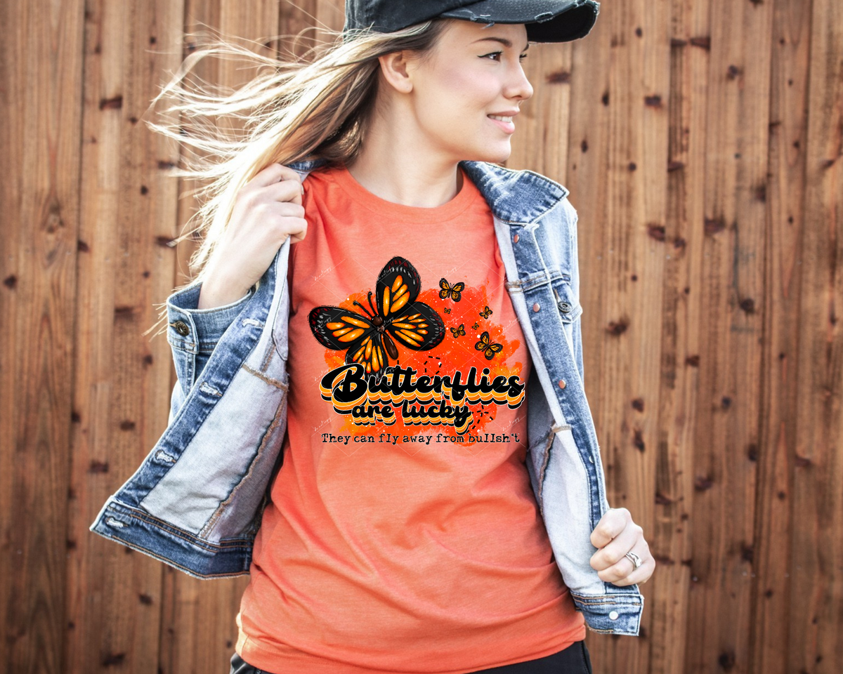Butterflies are lucky. They can fly away from bullshit (orange shades for color, 70's vibe font, butterflies) 1264 DTF TRANSFER