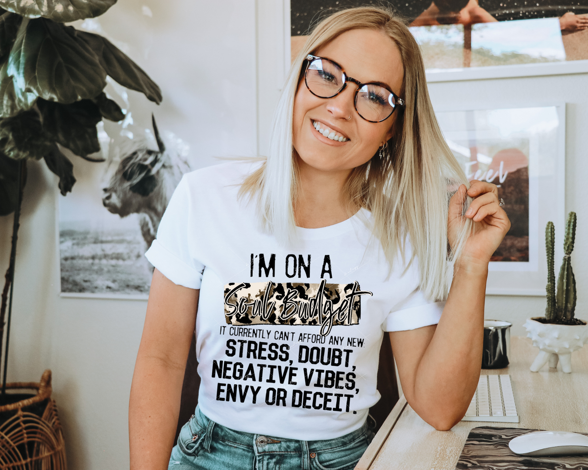 I'm On A Soul Budget It Currently Can't Afford Any New: Stress, Doubt, Negative Vibes, Envy Or Deceit. (leopard print block background with handwriting, and black lettering) 1984 DTF TRANSFER