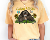 Feeling Slothee Need a Coffee (sloth hugging a coffee cup, sunflowers, hearts filled with western stripes, cursive lettering in yellow and black) 1393 DTF TRANSFER